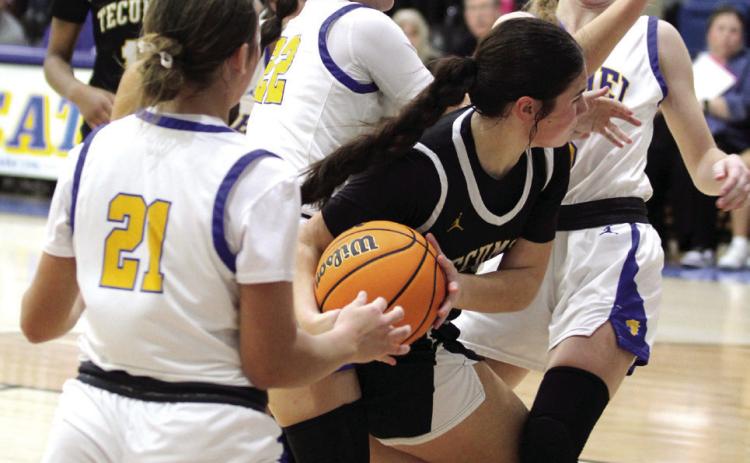 Tecumseh’s Peyton Bays grabs the rebound and is blocked by three Bethel defenders during the Bethel First United Tournament Consolation on Dec. 14. The Lady Savages lost to Eufaula, 27-33; won with Perkins-Tryon, 41-39; and fell to Bethel, 35-43. Countywide & Sun/Natasha Dunagan