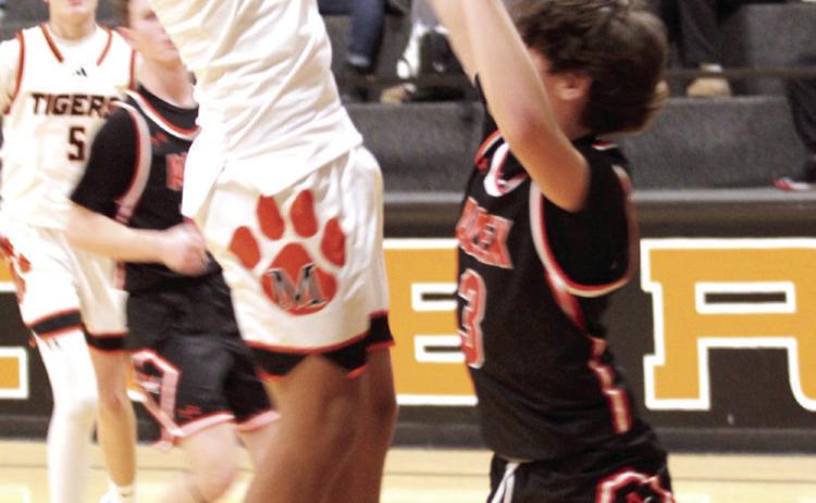 Maud freshman Koi Street aims for the basket during the Dec. 4 game against Alex in the Maud 8-Man Basketball Tournament. The Tigers hosted seven other teams in the three-day girls' and boys' tournament. They lost to Alex, 35-42; won against Fox, 65-35; and fell to Life Christian Academy, 60-37.