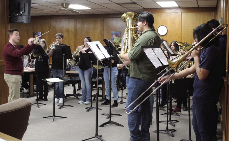 Shawnee High School Assistant Director of Bands Jackson Anderson conducts the 17-piece Jazz Band in “Carol of the Bells” during the Shawnee Board of Education meeting on Dec. 5. Countywide &amp; Sun/ Natasha Dunagan