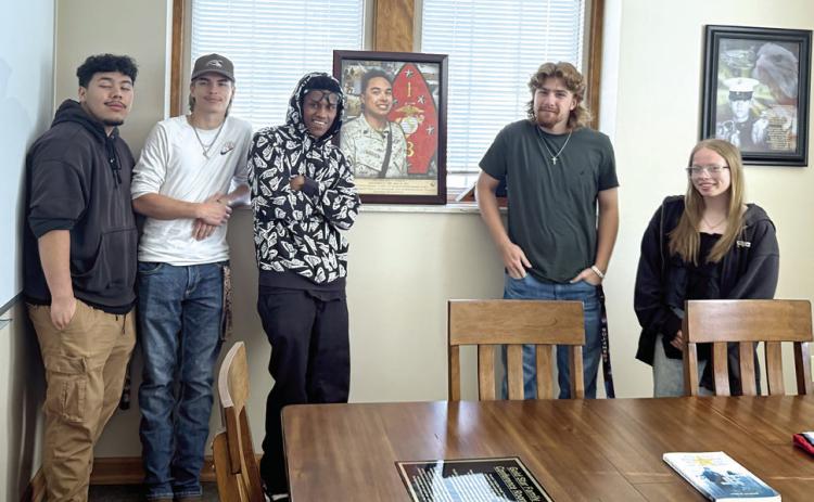 Earlsboro students pause from their County Buildings Tour to pose with a photo of HN (FMF) Eric D. Warren, the son of one of their teachers. Warren passed away on May 26, 2012, while serving in Afghanistan; he was 23 years old. Photos by Julie Talton, Countywide & Sun