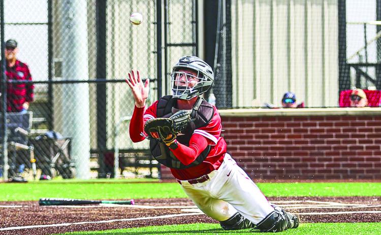North Rock Creek's catcher Landon Rosser, made a great diving catch for the out. NRC came up short in the fi rst game of the NRC festival against Heritage Hall, losing 3-6. They came back in the second game against Harrah, winning 8-0.