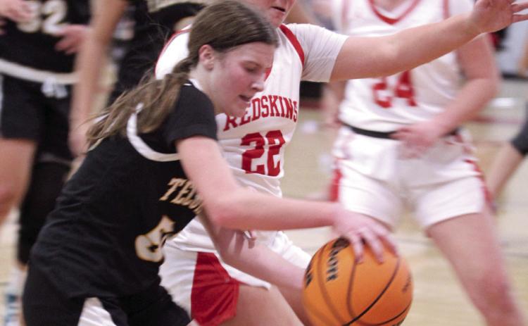 Tecumseh sophomore Sosi Mitchell brings the ball to her teammates, as McLoud's Anna Sharp tries to steal, during the Class 4A District Tournament home game on Feb. 21. The Lady Redskins won 79-30, and advanced to the Regional Tournament at home on Feb. 24. The Lady Savages play Ada in the Regional Consolation Bracket today (Feb. 26) in McLoud at 6 pm.