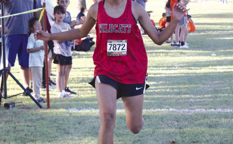 Earlsboro freshman Ana Roubidoux crosses the finish line in sixth place for the High School Girls Two-Mile division of the Tecumseh Savage Cross Country Invitational on Sept. 26. According to ohstrack. com, Roubidoux’s time girls team placed second. In addition to Earlsboro and Tecumseh, New Lima and Lexington participated in the evening event. Countywide &amp; Sun/ Natasha Dunagan