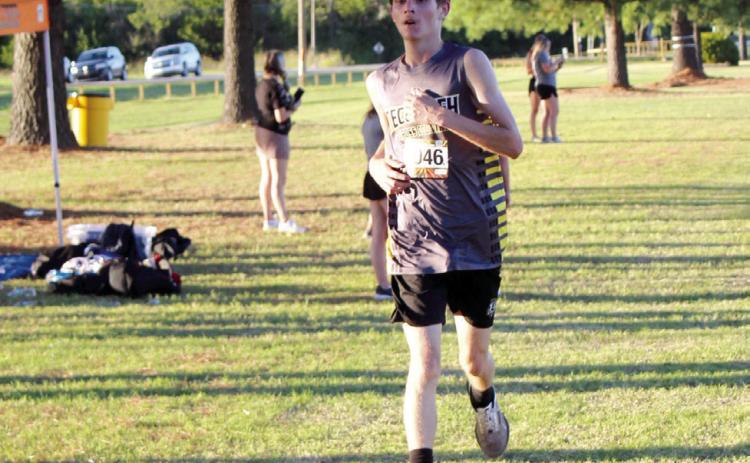 Tecumseh junior Tim Wallace crosses the finish line in third place during the Boys 5K Run with a time of 20:10.17. Countywide &amp; Sun/ Natasha Dunagan