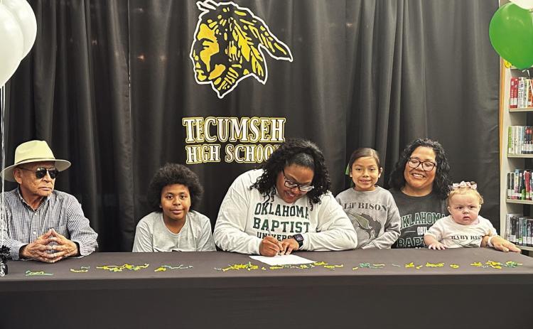 Tecumseh senior Kiara Stallin, center, signed a letter of intent with Oklahoma Baptist University for track on March 5. Stallin is shown with her family, from left, Tommy Kaskaske, Keelym Parks, Aniyah Masquas, Fallon Jackson and Makayla Allen. Photo provided by Casi Bays.