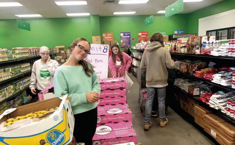 Dale FFA students assist in shopping at the Community Market of Pottawatomie County. Dale FFA placed second in the First United Bank Harvesting Impact contest in December 2024. North Rock Creek FFA placed first, and Shawnee High School FFA came in third. Photo provided by Jon Golliver.