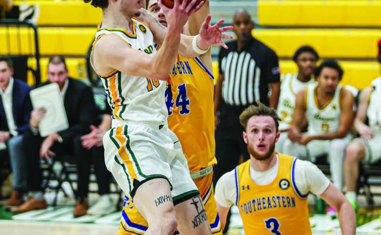Oklahoma Baptist University’s JC Curry goes for the shot among three Harding defensive players in the win Saturday, Jan. 11. The Bison take on Ouachita in a home game tonight (Thursday, Jan. 16). Tipoff is scheduled for 7:30 pm. Photo provided by OBU