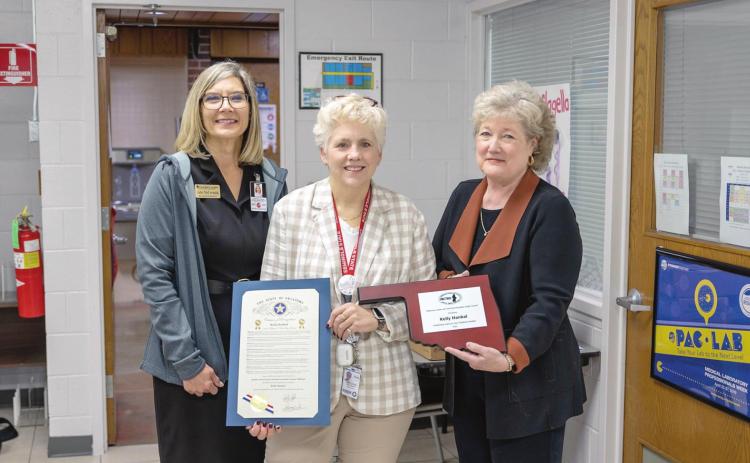 Gordon Cooper Technology Center Superintendent Julie McCormick (left) and Seminole State College President Lana Reynolds (right) congratulate MLT Program Director Kelly Hankal (center) on her Outstanding Instructor award. Photo provided