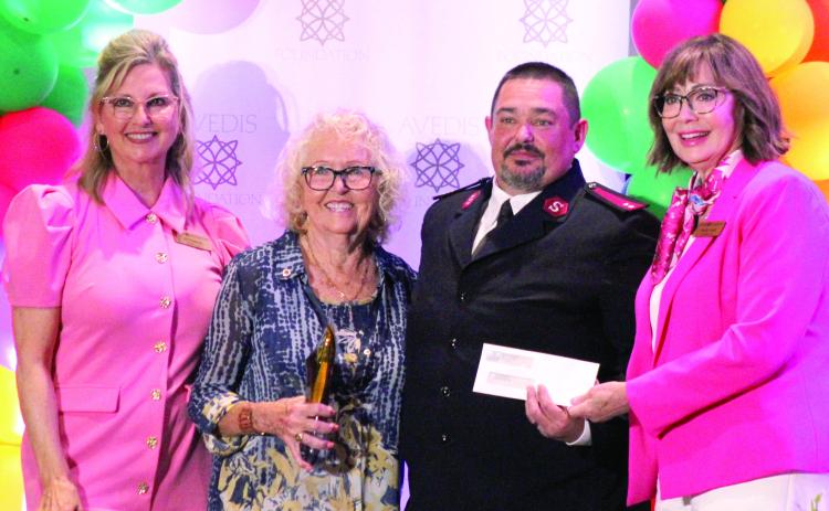 Sue Nelson, second from left, won the Michelle Briggs 'We're Here for Good' Service Award and chose the Salvation Army to receive the charity donation of $5000 that accompanied the award. Shown, during the Avedis Foundation Speaker Series Luncheon on May 28, from left, are Jill Spencer, Nelson, Salvation Army Captain Thomas Marion and Avedis CEO Dr. Kathy Laster. Photos by Natasha Dunagan, Countywide &amp; Sun
