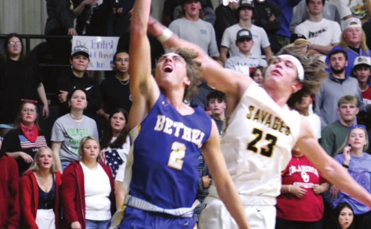 Bethel’s Xavier Meier makes two points after stealing the ball as Tecumseh’s Jaxon Meyers blocks during the Tecumseh home game on Dec. 3. Bethel won 77-56. Countywide &amp; Sun/Natasha Dunagan