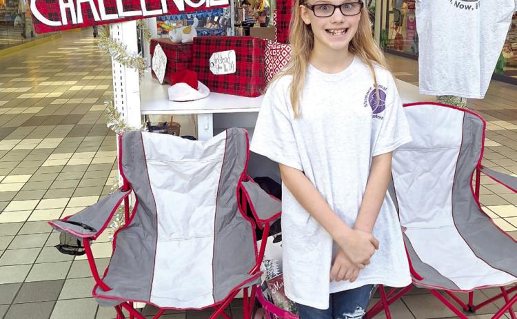 Bethel 4-H Vice President Ember Luna, 10, stands at a Shawnee Mall kiosk where she and her mother, Danielle Luna, took donations for her 1,000-Pound Challenge. They collected money and pet food donations to go towards the Shawnee Animal Shelter’s December Giveaway, benefitting the pets of those in need. Photo provided.