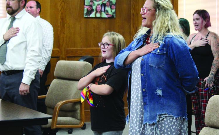 Shawnee fourth-grader Aurora Hall leads the Flag Salute next to Horace Mann Principal Jennifer Epperley during the Oct. 3 Shawnee Board of Education meeting. Countywide &amp; Sun/Natasha Dunagan