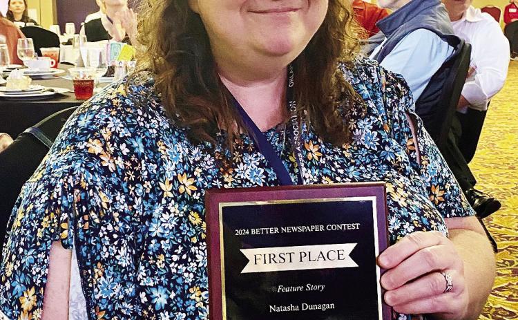 Natasha Dunagan poses with her first place Feature Story plaque at the OPA Awards Convention last weekend. 'I love writing feature stories. It is my way of helping get someone's story out to the public. It feeds the kid in me who loved listening to the grownups talk. I've always been curious about life stories.' Julie Talton, Countywide & Sun