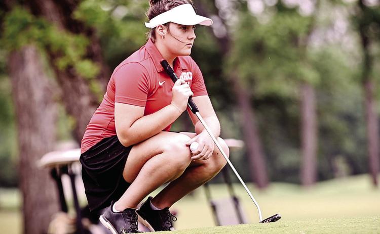 Junior Robyn Click looks at the green on the 17th hole of FireLake Golf Course on April 14.