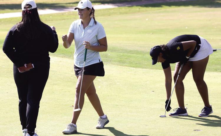 Oklahoma Baptist University senior Rylie Spaulding does a quick fist bump after a successful putt. Photo provided by OBU