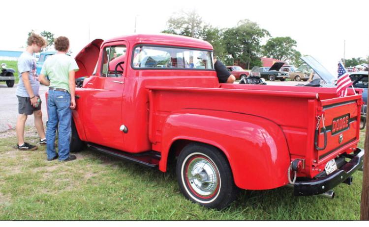 Two teens look over a 1956 Dodge C-3B during a car show held in Macomb on June 23. The car show was part of Macomb’s 21st Century Summer School Program, with a “Time Travel Summer” theme. This was 1950s week, said program director Shannon Browning, who added that they would also have a sock hop that day. They have also been to medieval, colonial and the 1980s, and will travel to the Wild West next. There were 26 cars in the show, which was organized by Andy Reich of Romulus Baptist Church.