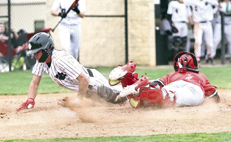 North Rock Creek's Jaxson Loftis slides past the catcher for the score. Photo courtesy of Gowin Photography