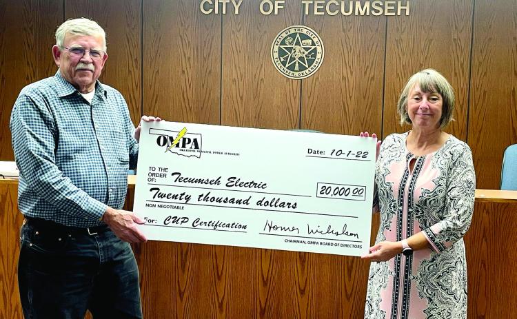 Tecumseh Mayor Eddy Parker accepts a $20,000 check from Oklahoma Municipal Power Authority Representative Palma Lowewith. Countywide &amp; Sun/Ryan Ackerman