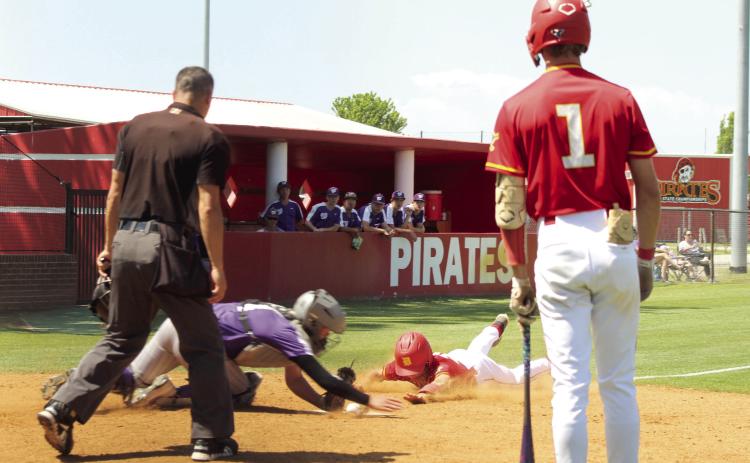 Dale junior Race Higdon dives to steal home, as senior Hunter Watkins waits to bat, during the Class 2A1 Regional Tournament home game against Wilburton on May 8. The Pirates won all three games: two with Wilburton, 12-0 and 19-0, and one with Riverside, 16-0, in the two-day tournament.