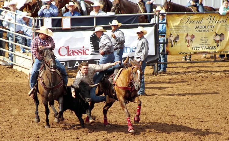 Dally Trussell, of McLoud, dismounts from his horse to grab a steer and wrestle it during the International Finals Youth Rodeo, at the Heart of Oklahoma Expo Center on July 9. Countywide & Sun/Natasha Dunagan