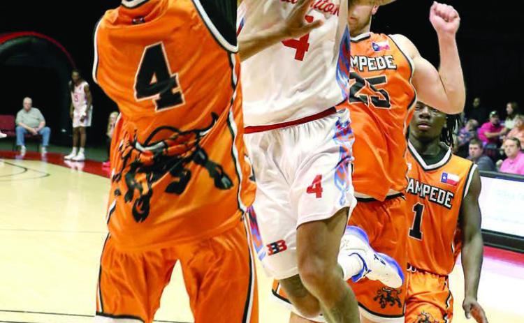 Potawatomi Fire Guard Chuck Guy goes to the hoop in the Mother's Day home game against the Dallas Stampede, held at FireLake Arena. According to their website at potawatomifire.com, Guy scored the first Fire quadruple double with 33 points, 15 rebounds, 39 assists and 10 steals in the game. The Fire won with a final score of 191-84, breaking team records for points, margin of victory, assists (57), steals (28), field goals (72) and field goal percentage (66.1). Photos courtesy of Kent Bush, CPN