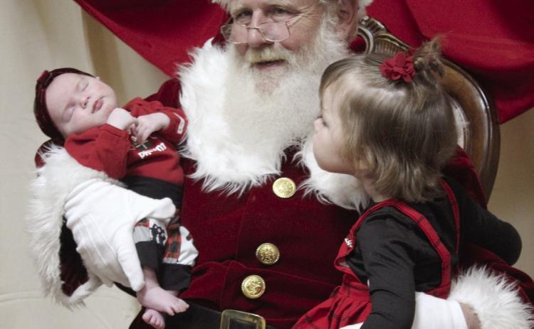 Santa holds GwendoLynn Newhoff, one month, and KaMaya Napier, 3, both of Shawnee, during the Grinchmas Whoville event, held in the Tecumseh City Hall Auditorium on Nov. 30. Both “Selfies with Santa” and the Grinch photos were sponsored by the Tecumseh Pioneer Library. Countywide & Sun/Natasha Dunagan