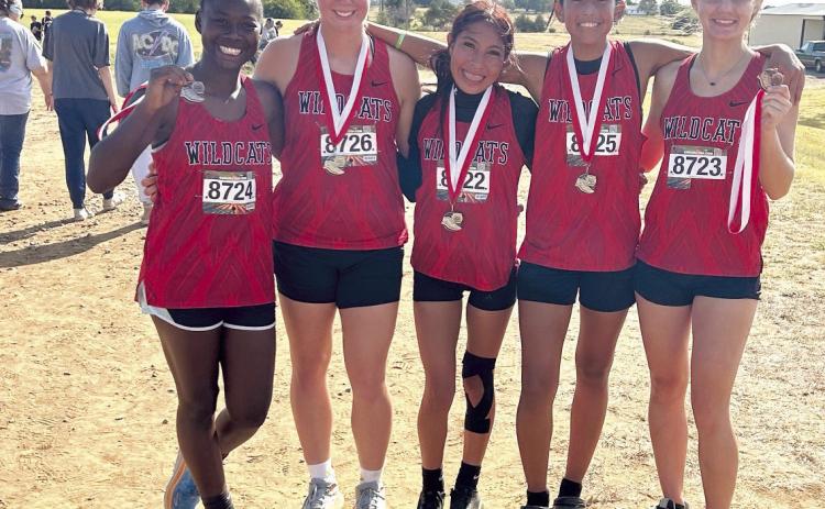 Pictured from left are Zeaonna McGregor, Peighton Worley, Karmalea Howell, Aha Roubidoux, and Xalina McCarroll. For the second week in a row, the EHS Lady Wildcats claimed Runner Up in The Heartland Championship cross country race held at North Rock Creek, and all five team members medaled. Freshman Peighton Worley took seventh, sophomores Karmalea Howell and Aha Roubidoux placed eighth and ninth, respectively. Freshman Zeaonna McGregor placed 11th and junior Xalina McCarroll placed 15th.