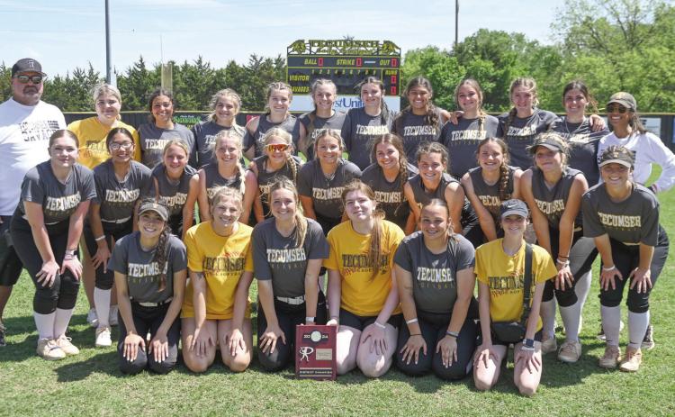 The Tecumseh Lady Savages and their coaches, Perry Wilson and Kayla Rodriguez, pose with their Class 5A District Slowpitch Softball Champion trophy on April 17. They beat Blanchard, 13-2; Crooked Oak, 15-0; and Blanchard, a second time, 10-3. The Lady Savages are scheduled to play in regionals at home today (April 25) at noon and 2:30 pm. Photo provided by Kenetta Lisenbee.