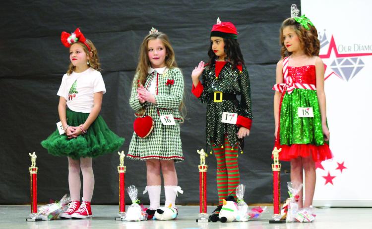 Hazel Mack of Shawnee; Kathryn Ashmore of Bethel; Prestynn Neely of Shawnee; and Peyton Neely of Shawnee each won a trophy at the Our Diamond Miss Christmas Pageant, held at Will Rogers Elementary School on Dec. 7. In their age division, Mack won Fashion Queen; Ashmore took Most Photogenic; Prestynn Neely won Most Beautiful; and Peyton Neely got Division Supreme. Countywide & Sun/ Natasha Dunagan