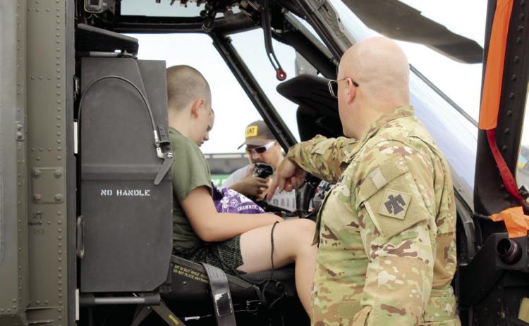 Chief Warrant Officer #3 Ryan Johnson, with the OK Army National Guard out of Tulsa, points to the controls in a UH-60 M Black Hawk helicopter. Johnson said he has been in the U.S. Army a total of 22 years in the infantry, then aviation. There were also helicopters from the U.S. Customs & Border Protection and Air Evac.