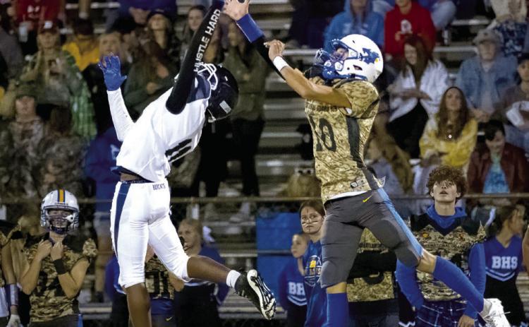 Bethel junior Reagan Curry (#10) and a Star Spencer player try to catch a pass during the Military Appreciation Night home game on Oct. 13. The Bethel Wildcats won 40-38. Photo provided by Richelle Treece.