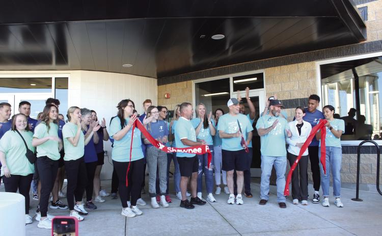 Everyone applauds as Shawnee YMCA CEO Mike Jobe cuts the ribbon, with the help of board members, employees, and others, to officially reopen the Troy and Dollie Smith Family YMCA on April 6, almost a year after it was hit by the April 19, 2023 tornado. Jobe later said approximately 1,800 people attended the Grand Reopening party. File photo