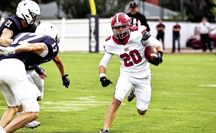 Hunter Bertram tries to go around the Marlow defense in the season opener Aug. 29. Photos Courtesy of Gowin Photography