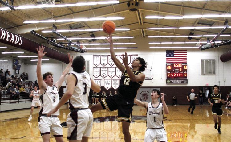 Tecumseh's Sherman Mitchell aims at the bucket during the second quarter of the Class 4A Districts at Eufaula on Feb. 21. The Savages made a three-point shot in the last two seconds to win, 69-67. Photo courtesy of Rodney Haltom/Eufaula Indian Journal