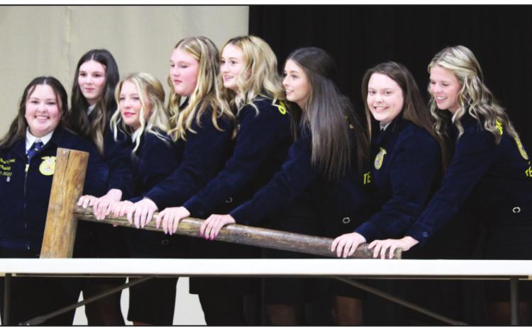 The 2021-2022 Tecumseh FFA Board members use a giant gavel to call the annual FFA Banquet to order on May 12. They are, from left, Dusti Ozment, Rylee Williams, Marli Williams, Piper Goodson, Chloe Kelsey, Jocelyn Phelps, Maci Flowers and Katelyn Fleming. After qualifying for a second time, the board reorganized, and the same members will serve again for the 2022-23 school year. Countywide &amp; Sun/Natasha Dunagan