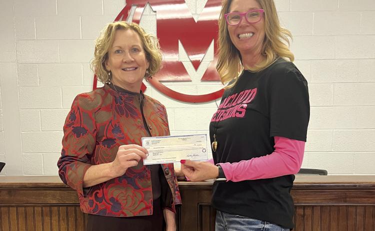 Audrey Seeliger, External Relations-Special Events for fhe Avedis Foundation, presents a check to Rhonda Hockenbury (left), Superintendent McLoud Public Schools. Photo provided