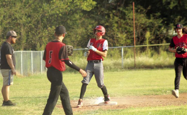 After hitting a triple, Earlsboro junior Cameron Black lands on third base.