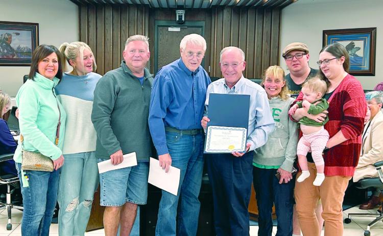 Mayor Ed Bolt presents a certificate of recognization to the family of Ann Davis who passed away in early Sept. Receiving the certificate is her son Trey surrounded by multiple family members. Countywide & Sun/Suzie Campbell