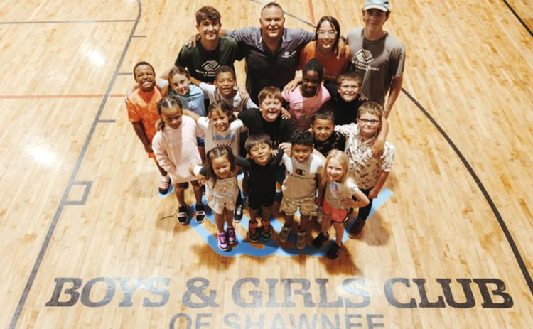 Julio Sanchez, back row and second from left, the director, poses with mentors and club kids at The Salvation Army Boys and Girls Club at Shawnee. Photo provided