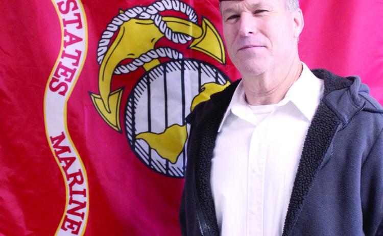 Retired Veteran David Baker poses with the U.S. Marine Corps flag. Baker served for 11 years in Combat Arms, working on tanks, and for another 11 years in Electronics before retiring from the Marines. Natasha Dunagan, Countywide &amp; Sun