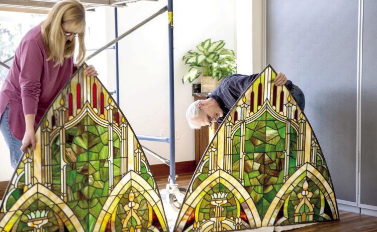 Rebecca and Tim Brown check sections of the stained-glass window for accuracy before mounting. Photos by Stephanie with Fritz Frameables, LLC
