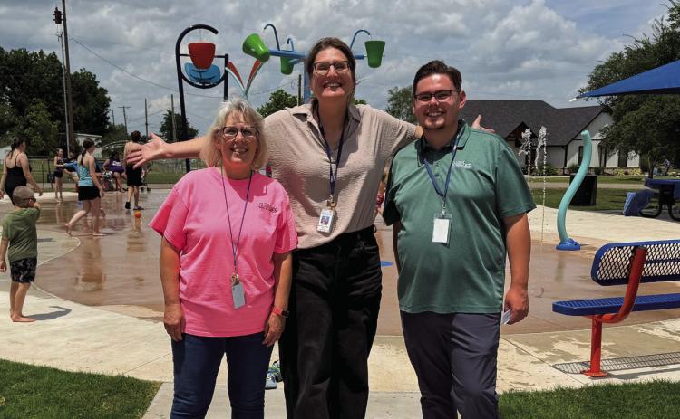 Shawnee Parks and Recreation staff members Jane Wright, Kerri Foster, and Cord Bender celebrate the opening of Optimist Park Splash Pad. Photo Provided