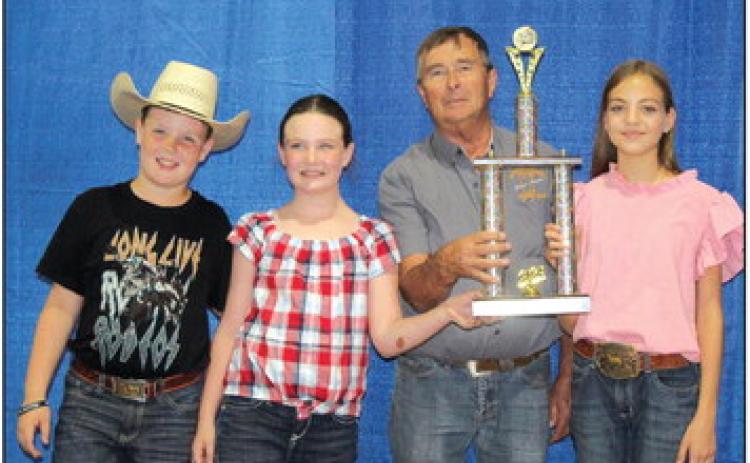 Members of Dale 4-H accept the 4-H and FFA Beef Herdsman Award on Sept. 9 from Pottawatomie County Free Fair Board Member Lynn Marlow. They are, from left, Bryar Baker, Taycie Baker and Katie Haysmer. Countywide & Sun/Natasha Dunagan