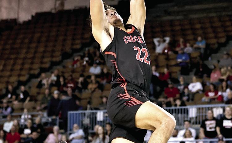 North Rock Creek's Caleb Hawkins goes up for the dunk. NRC won the first round of the State games, beting Bethany 61-56. The Cougars lost to Weatherford, 58-68, Friday, Mar. 14 in the semi-finals. Weatherford went on to claim the State Championship title. Photo courtesy of Gowin Photography