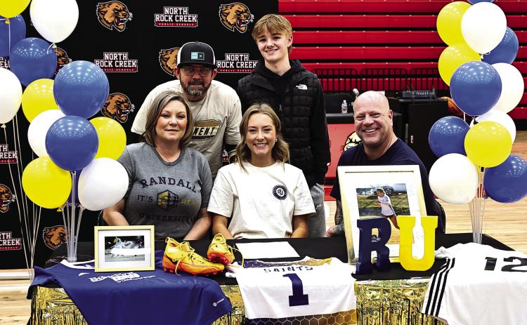 Pictured left, North Rock Creek’s Caitlin Walls signed her letter of intent to attend Randall University next year to play soccer. Watching her was her family, David Walls, Donny &amp; Alisha Armitage, and Bronson Armitage. Photo courtesy of Gowin Photography