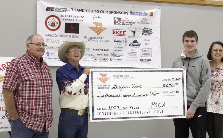 Greyson Wood of Dale poses with a display check for $2,700 after winning first place in the Second Annual Pottawatomie County Cattlemen's Association Beef Quiz Bowl on Nov. 4. Also shown are Wood's grandfather, Steven Rasure, far left, PCCA President Bob Freeman, and grandmother, Deborah Rasure, far right. Wood received a $200 bonus since his grandparents are members of the PCCA. Second place went to Stephen Wickard of North Rock Creek, and third place went to Austin Ramsey of Tecumseh.