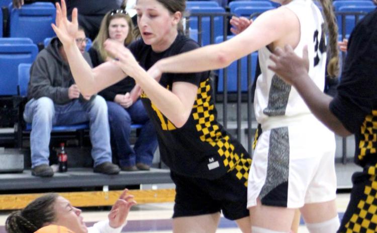 Tecumseh’s Kenzli Warden has the ball knocked out of her hands by one Perkins-Tryon defender and nearly trips on another on her way to the basket during the First United Bank Classic consolation championship round in Bethel on Dec. 11. The Lady Savages won that game, 39-35. They lost to Byng in the first round on Dec. 9, 37-54, and won against Bridge Creek, Dec. 10, 74-32. Countywide &amp; Sun/Natasha Dunagan