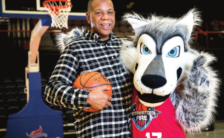 Potawatomi Fire Head Coach Derrick Rowland poses with Mo’ewé, or Mo, the team mascot. Mo’ewé (Mo-Eh-Weh) is the Potawatomi word for wolf. Photo provided by CPN