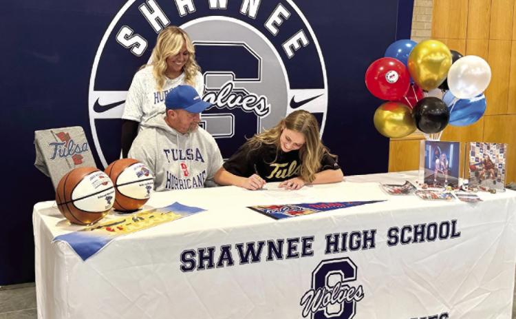 Shawnee senior Josie Megehee signs a letter of intent with the University of Tulsa to play basketball in Division 1 of the American Athletic Conference on Nov. 29. Megehee is pictured with parents, Brandon and Leslie Megehee. Photo provided by Amanda Johnson.
