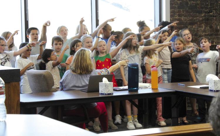 The Sequoyah Elementary School fourth-grade choir, led by Jana Stelzer, sing “Forward” during the Sept. 9 Shawnee Board of Education meeting. Countywide & Sun/Natasha Dunagan